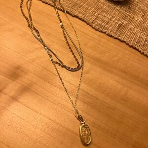 Kendra Scott multi chain with clear stone and mini daisy flower pendant.